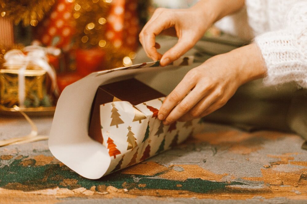 a person wrapping a gift